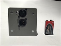 View of the top of the device, with battery for scale